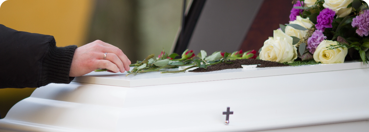 closeup-shot-person-hand-casket-with-blurred-background@2x